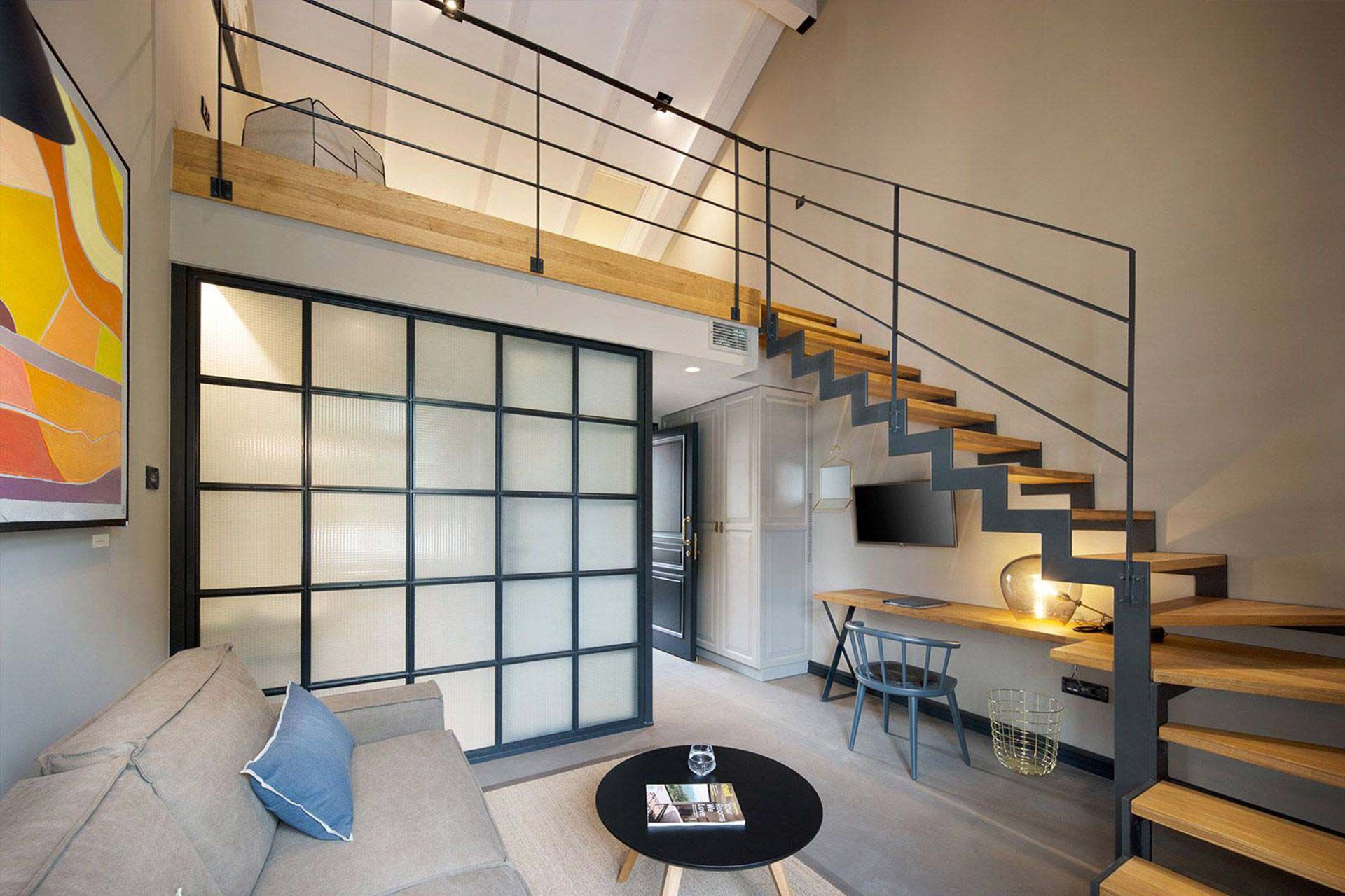 Experience boutique interior design in a luxurious modern suite with elegant stairs and a comfortable sofa bed - Discover the Deluxe Mezzanine Double Room at Almayer Art & Heritage Hotel in Zadar, Croatia