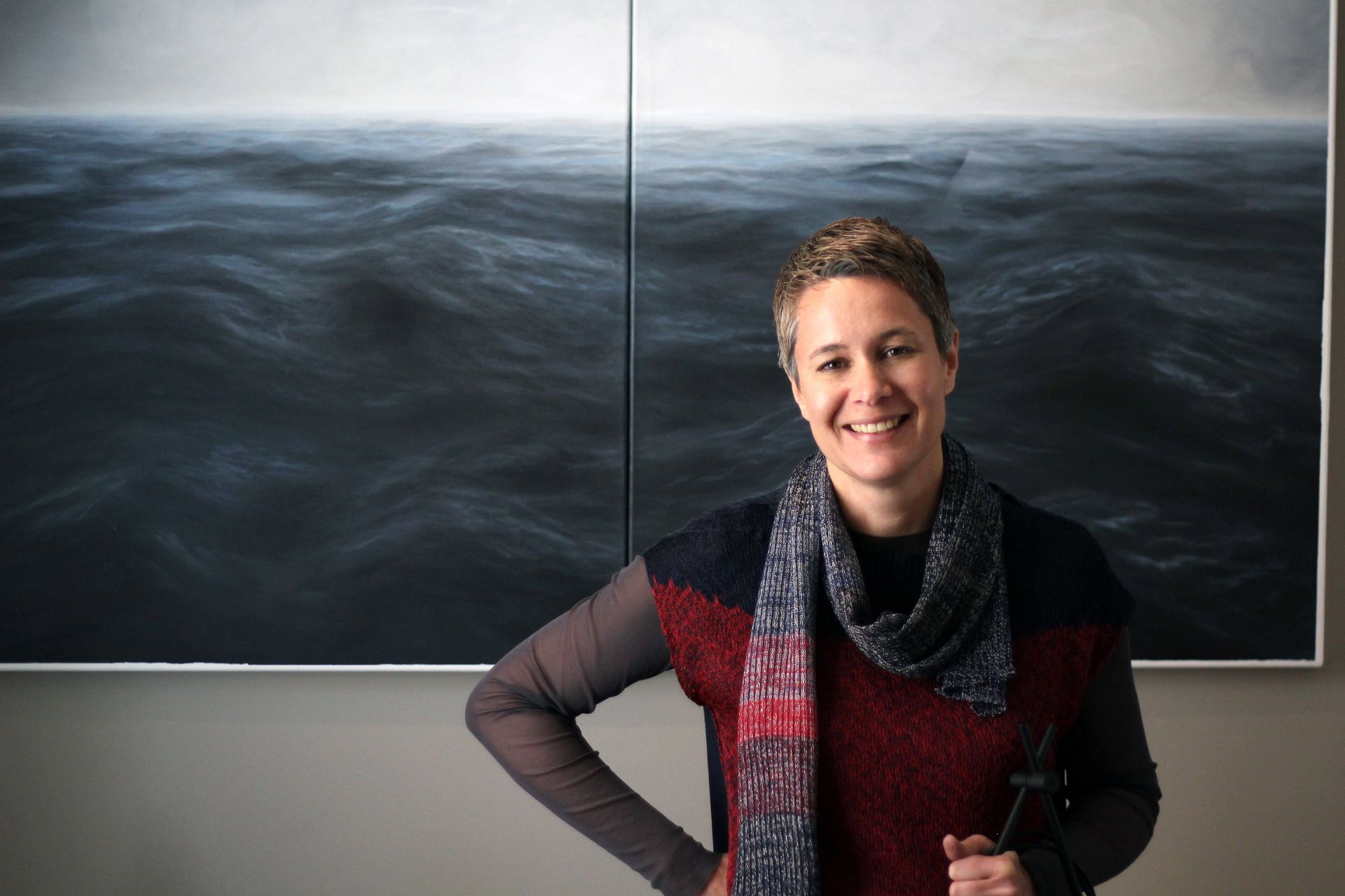 Owner of the Almayer Art & Heritage Hotel, Irina Bakija stands in front of Andrea Musa’s painting