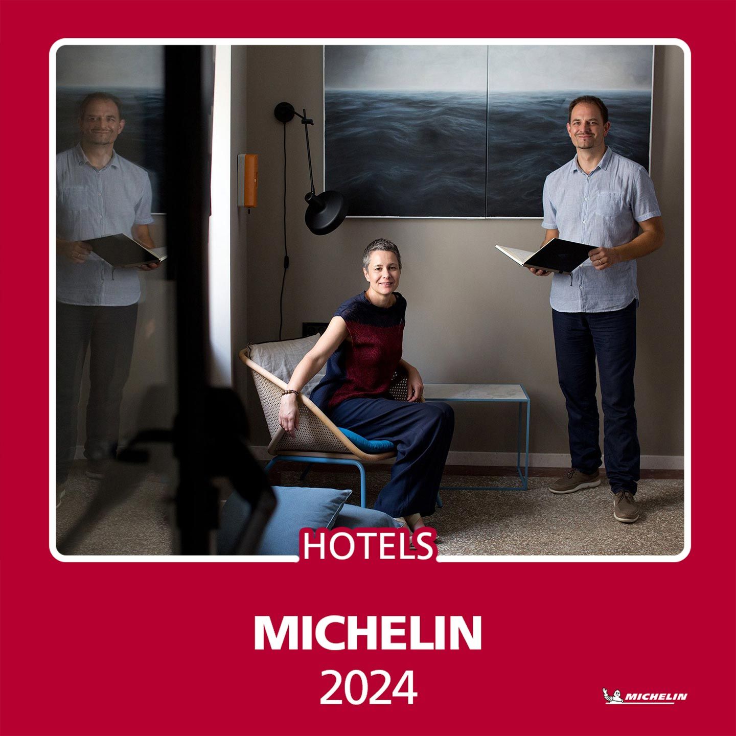 Almayer Art & Heritage Hotel owners pose in the beautiful hotel interior, celebrating their Michelin Guide 2024 best hotel recognition.
