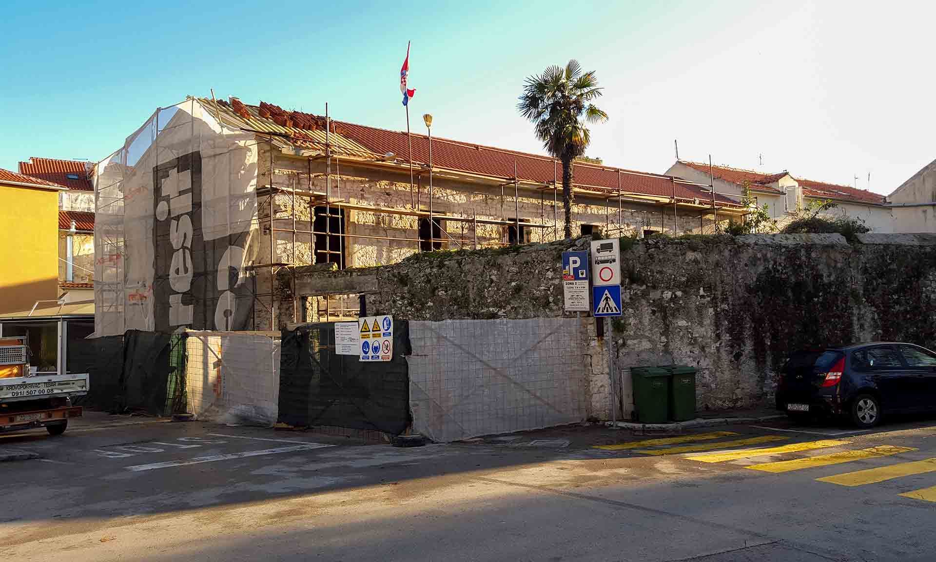 The Almayer future hotel building during its roofing with traditional curved tiles, marking the completion of roof work in 2016.