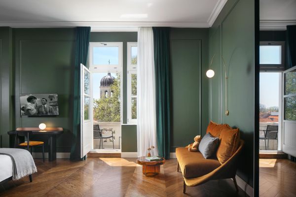 Experience timeless elegance in the Deluxe double room 'Gjika' at Almayer Art & Heritage Hotel's annexe building, featuring a plush sofa, a balcony with breathtaking views of the park, city, and majestic sea